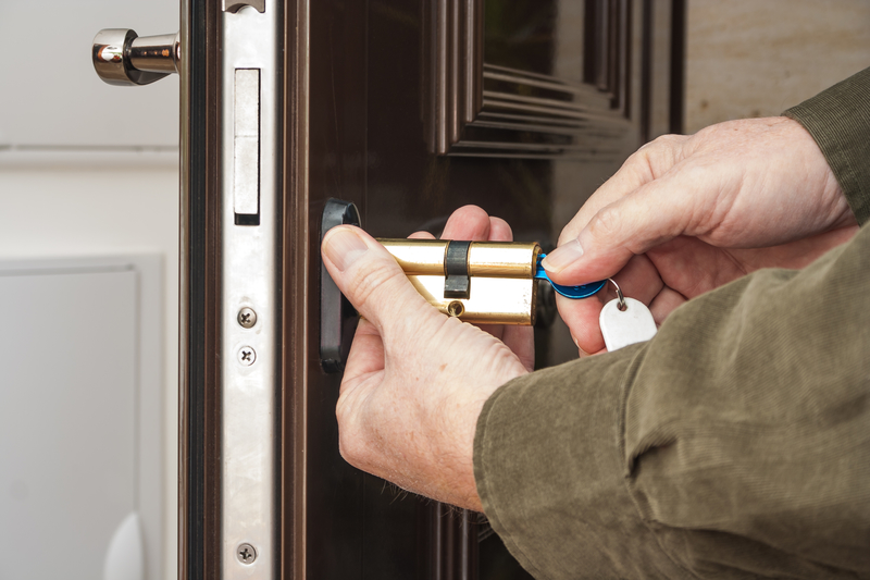 Locksmith replacing a cylinder lock