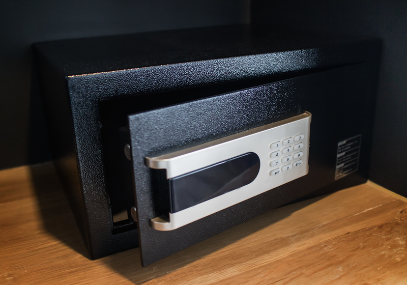 An open empty black safe box or modern electronic locker in hotel room or home.